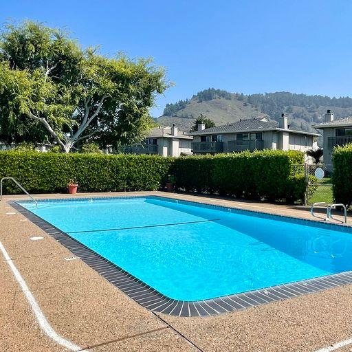 3850 Rio Road, Unit 91 Carmel, CA 93923 - Photo 30 of 31 a view of a house with a swimming pool