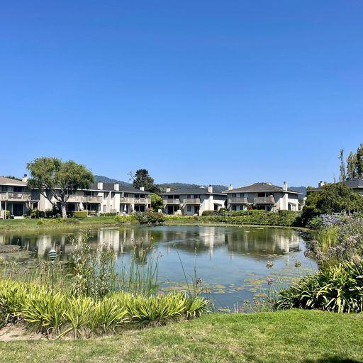 3850 Rio Road, Unit 91 Carmel, CA 93923 - Photo 31 of 31 a view of a lake with houses in the background