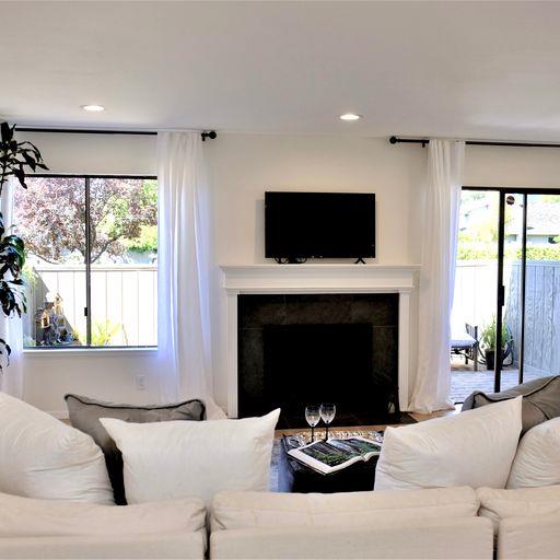 3850 Rio Road, Unit 91 Carmel, CA 93923 - Photo 5 of 31 a living room with furniture a fireplace and a flat screen tv