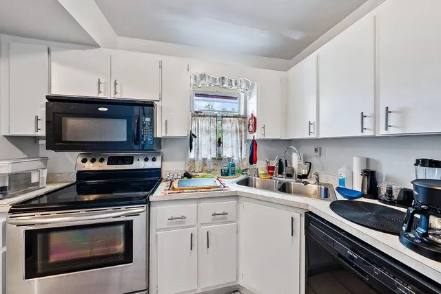 a living room with furniture and a large window with outer view