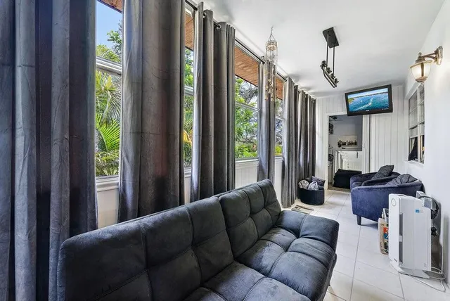 a living room with furniture and a floor to ceiling window