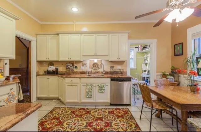 a kitchen with a stove a sink and a refrigerator