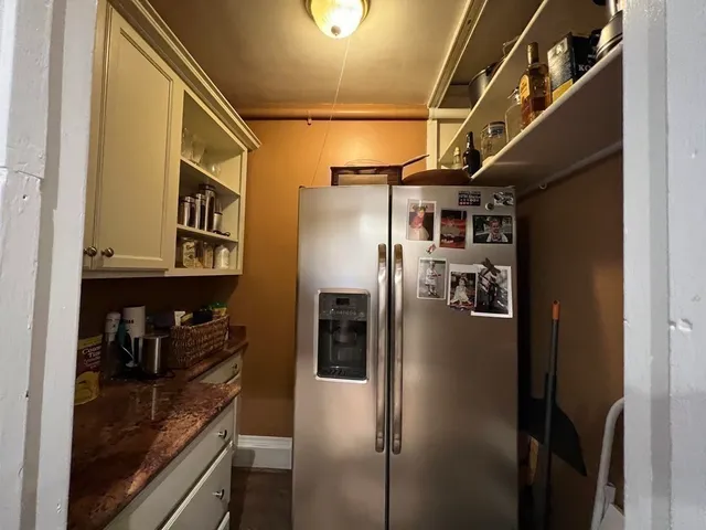 a kitchen with stainless steel appliances granite countertop a refrigerator and a sink