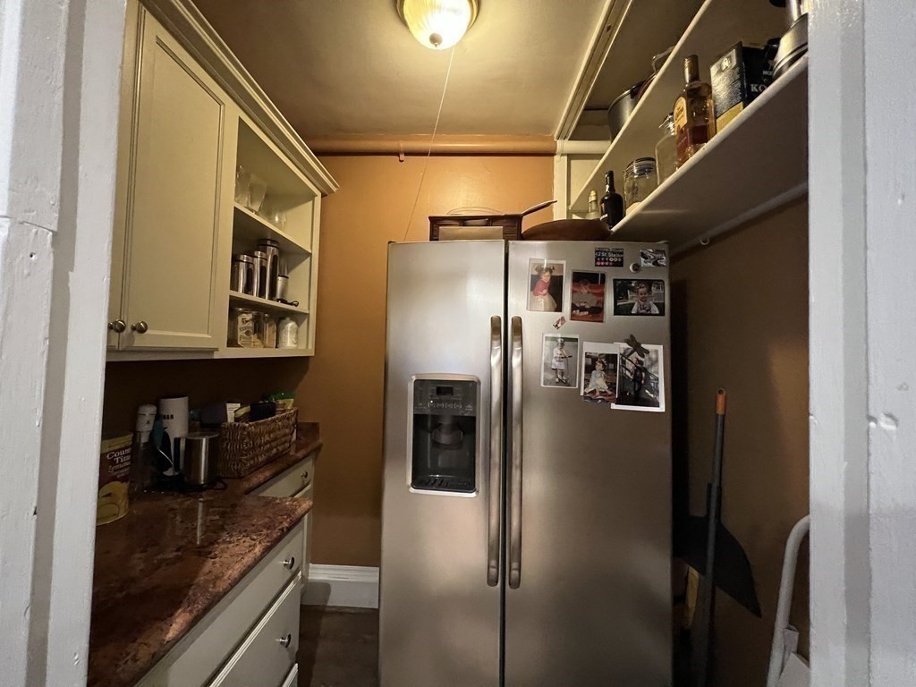 53 University Road, Unit 1 Brookline, MA 02445 - Photo 11 of 27 a kitchen with stainless steel appliances granite countertop a refrigerator and a sink