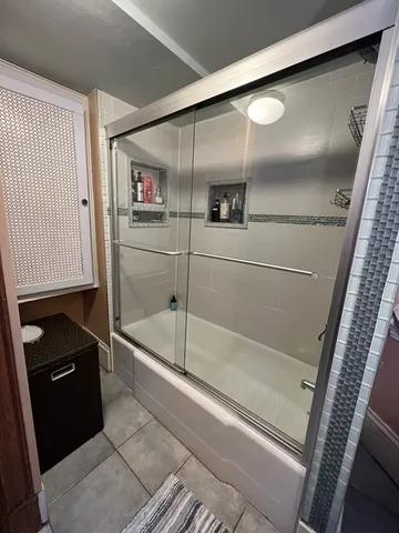 a bathroom with a bathtub and a shower