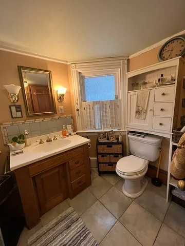 a bathroom with a sink toilet and mirror