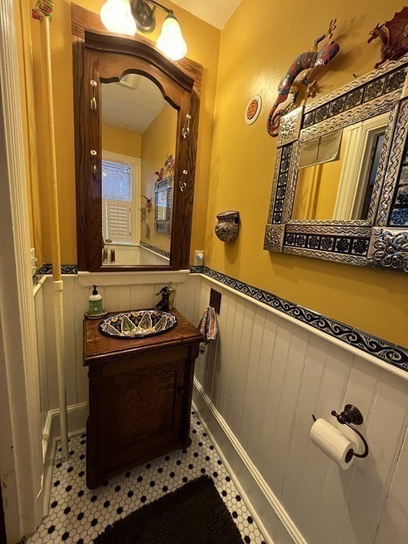 53 University Road, Unit 1 Brookline, MA 02445 - Photo 16 of 27 a bathroom with a sink a mirror and a shower