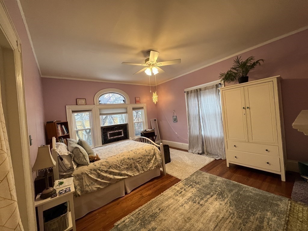 53 University Road, Unit 1 Brookline, MA 02445 - Photo 19 of 27 a bed room with a bed and a ceiling fan