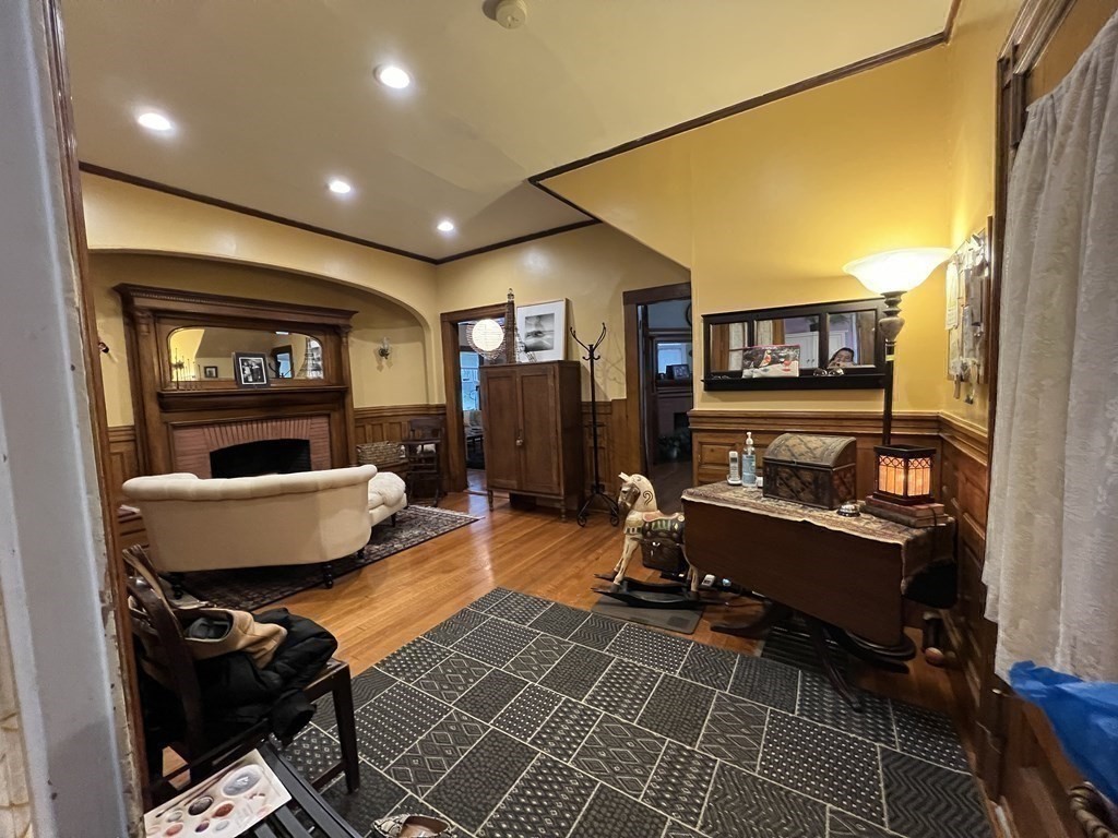 53 University Road, Unit 1 Brookline, MA 02445 - Photo 22 of 27 a living room with furniture and a flat screen tv