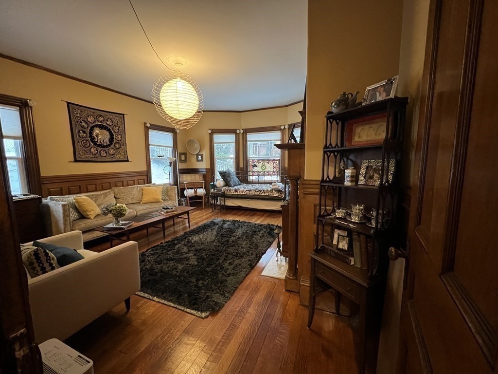 53 University Road, Unit 1 Brookline, MA 02445 - Photo 25 of 27 a living room with furniture and a rug