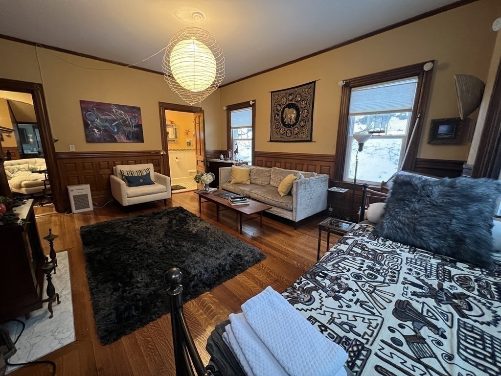 53 University Road, Unit 1 Brookline, MA 02445 - Photo 26 of 27 a living room with furniture and a chandelier