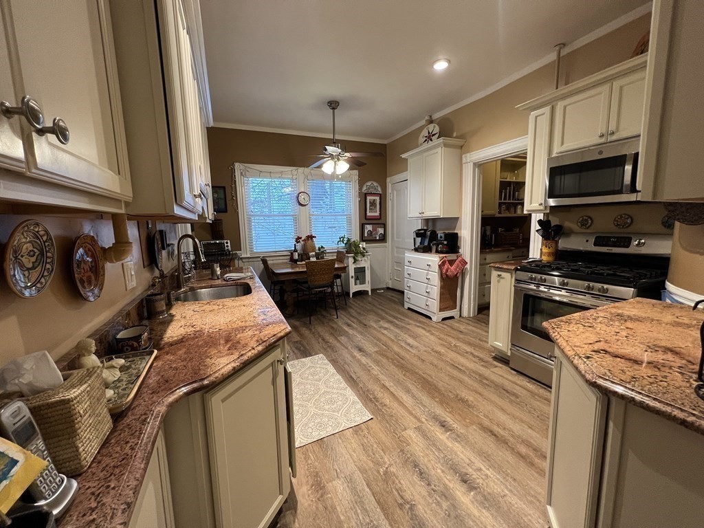 53 University Road, Unit 1 Brookline, MA 02445 - Photo 7 of 27 a kitchen with stainless steel appliances granite countertop a sink stove and refrigerator