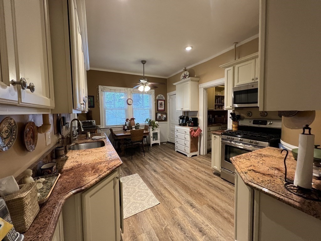 53 University Road, Unit 1 Brookline, MA 02445 - Photo 8 of 27 a kitchen with stainless steel appliances granite countertop a sink stove and refrigerator