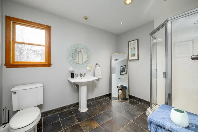 a bathroom with a toilet sink shower and mirror