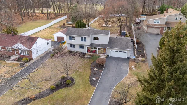 a aerial view of a house with large trees