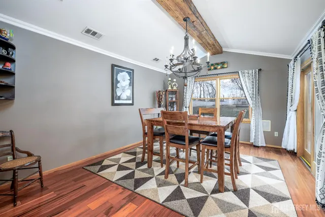 a view of a dining room with furniture and chandelier