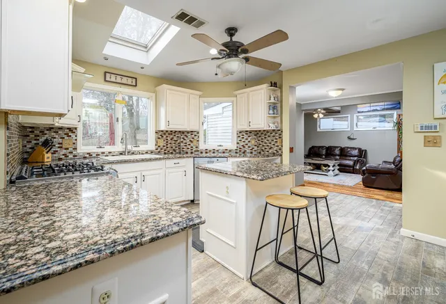 a kitchen with stainless steel appliances granite countertop a sink and cabinets