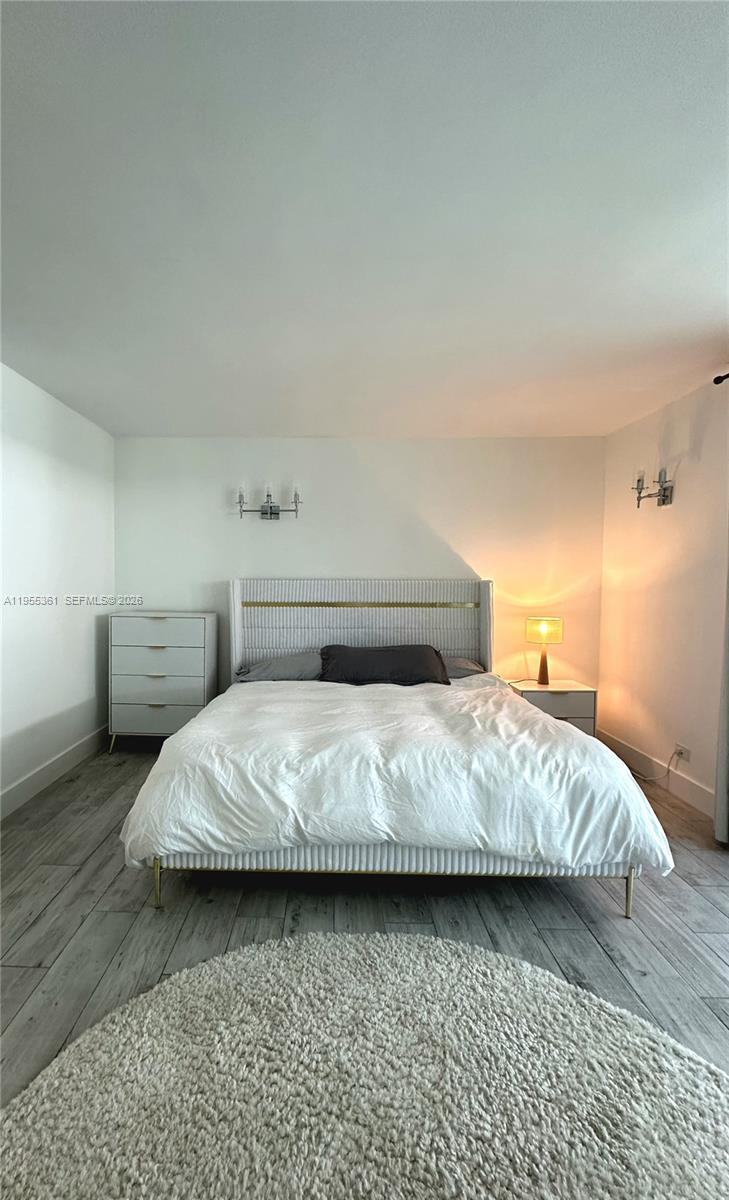 2301 Collins Avenue, Unit 321 Miami Beach, FL 33139 - Photo 11 of 16 a bedroom with a bed and lamp