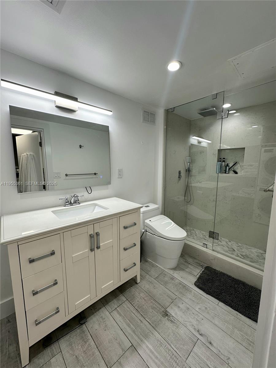 2301 Collins Avenue, Unit 321 Miami Beach, FL 33139 - Photo 15 of 16 a spacious bathroom with a double vanity sink toilet and shower