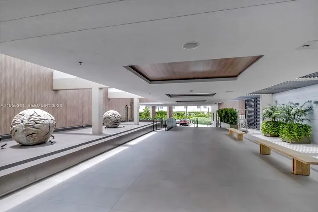 a view of a hall way with gym equipment