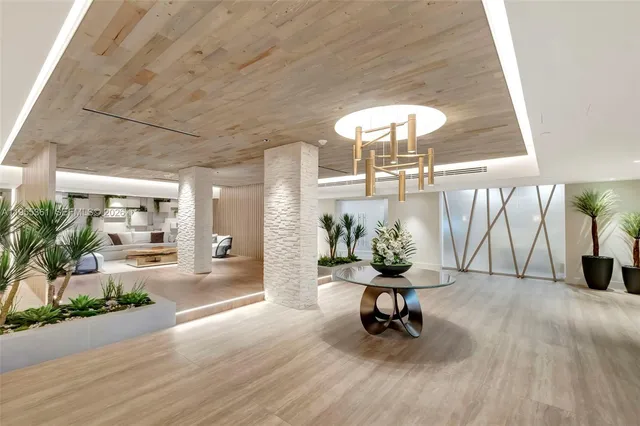 a living room filled with furniture and a chandelier