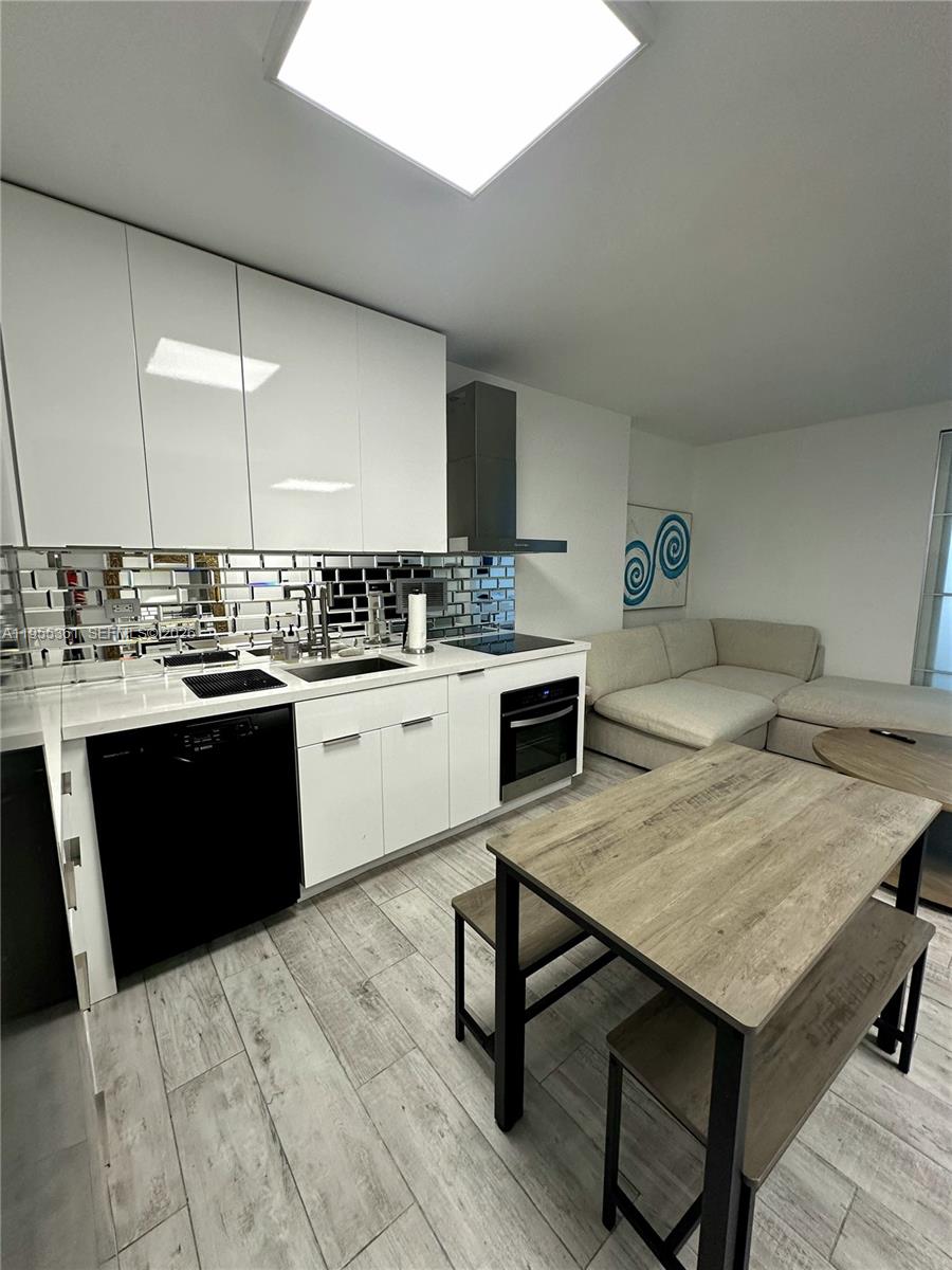 2301 Collins Avenue, Unit 321 Miami Beach, FL 33139 - Photo 9 of 16 a kitchen with a sink cabinets and wooden floor
