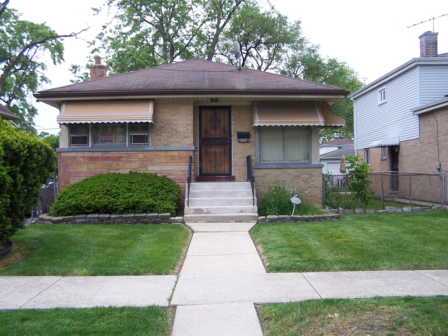 a front view of a house with a garden