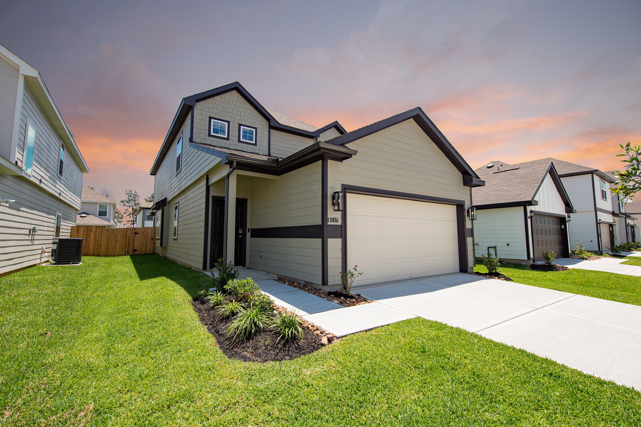 13651 Kit Run Splendora, TX 77372 - Photo 2 of 27 a front view of a house with a yard and garage