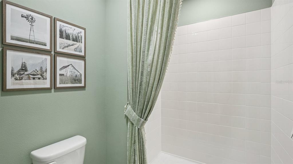 32507 Welling Blade Loop Wesley Chapel, FL 33545 - Photo 21 of 39 a bathroom with a toilet and a shower