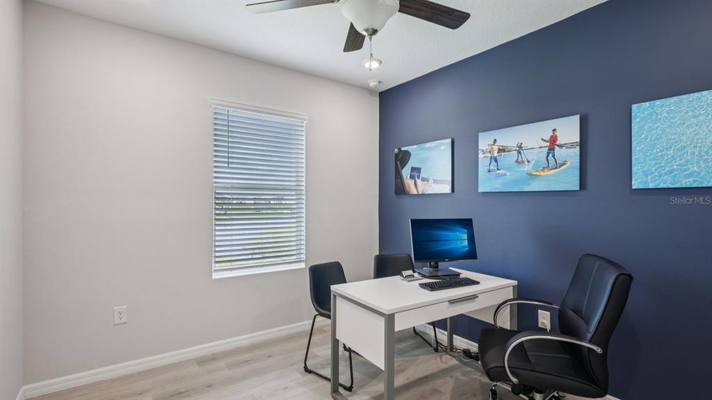32507 Welling Blade Loop Wesley Chapel, FL 33545 - Photo 24 of 39 a view of a workspace with furniture and a window
