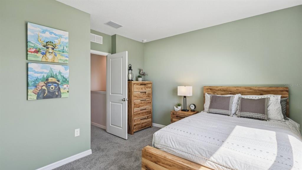 32507 Welling Blade Loop Wesley Chapel, FL 33545 - Photo 27 of 39 a bedroom with a bed and a walk in closet