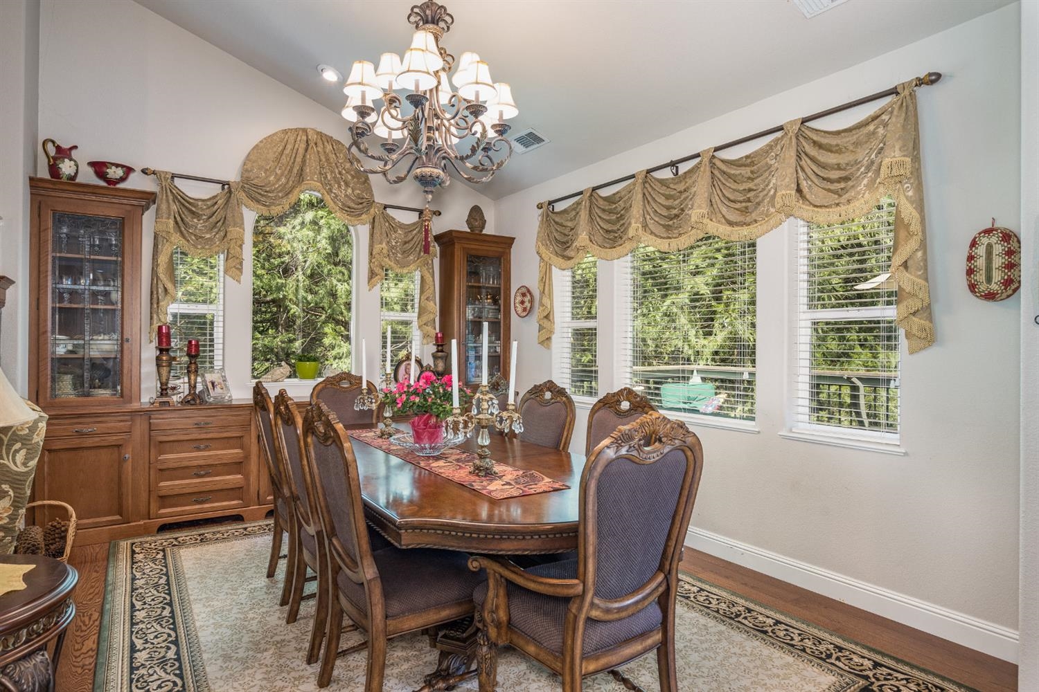 7703 Forest Drive Fish Camp, CA 93623 - Photo 11 of 48 a view of a dining room with furniture a chandelier and large window