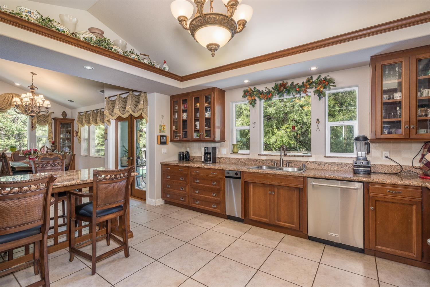 7703 Forest Drive Fish Camp, CA 93623 - Photo 17 of 48 a kitchen with a sink and chairs