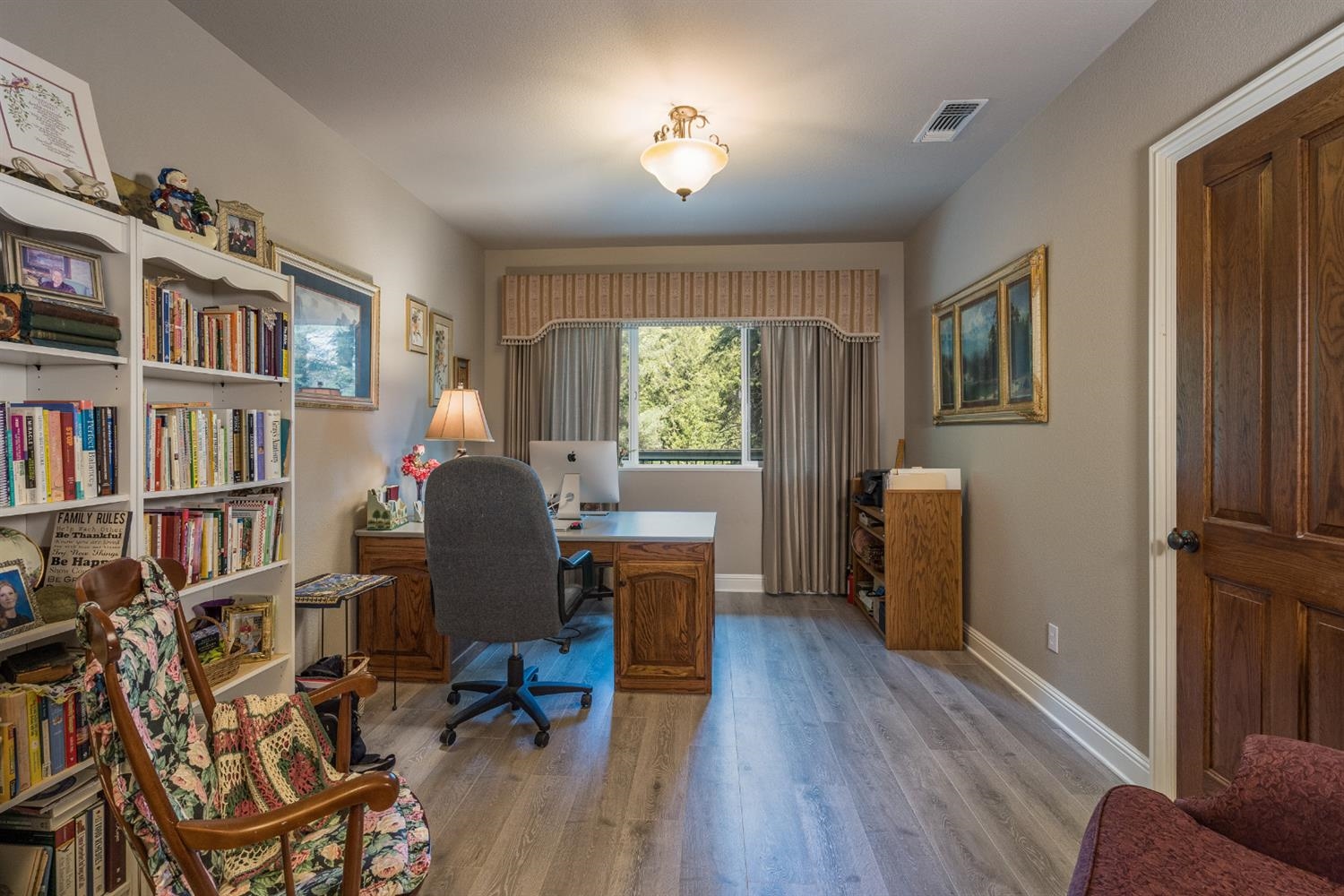 7703 Forest Drive Fish Camp, CA 93623 - Photo 20 of 48 a view of a workspace with furniture and a bookshelf