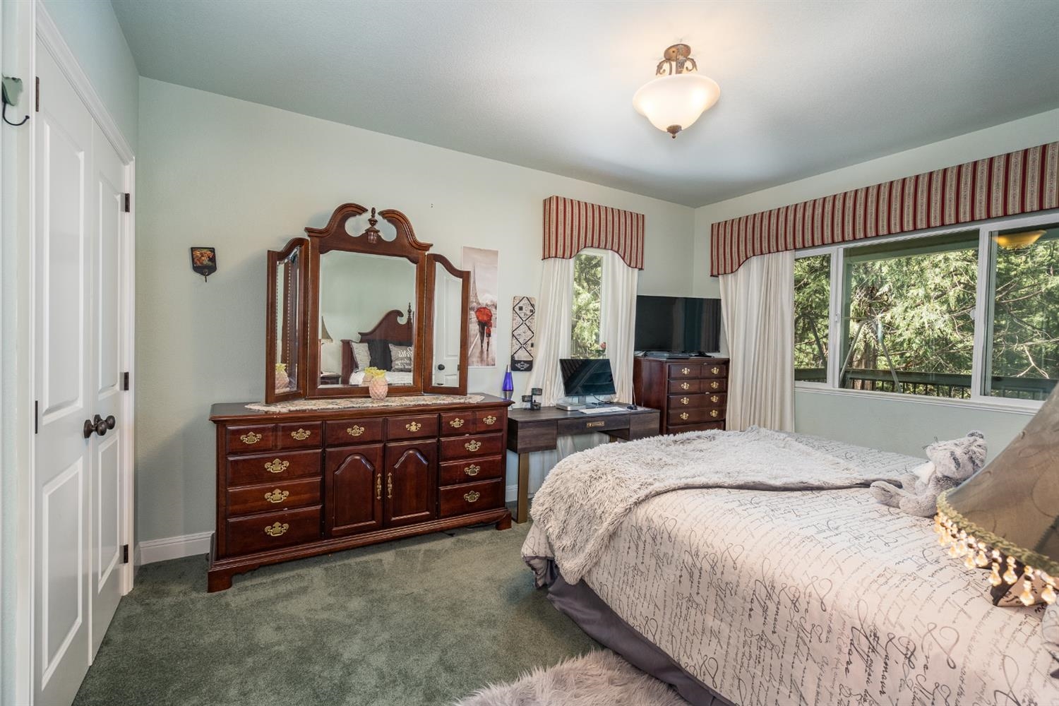 7703 Forest Drive Fish Camp, CA 93623 - Photo 26 of 48 a bedroom with a bed and a large dresser