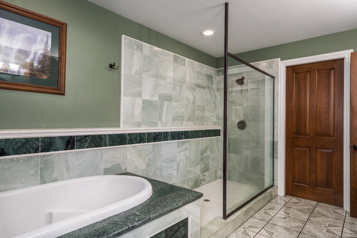 7703 Forest Drive Fish Camp, CA 93623 - Photo 37 of 48 a bathroom with a granite countertop bathtub and shower