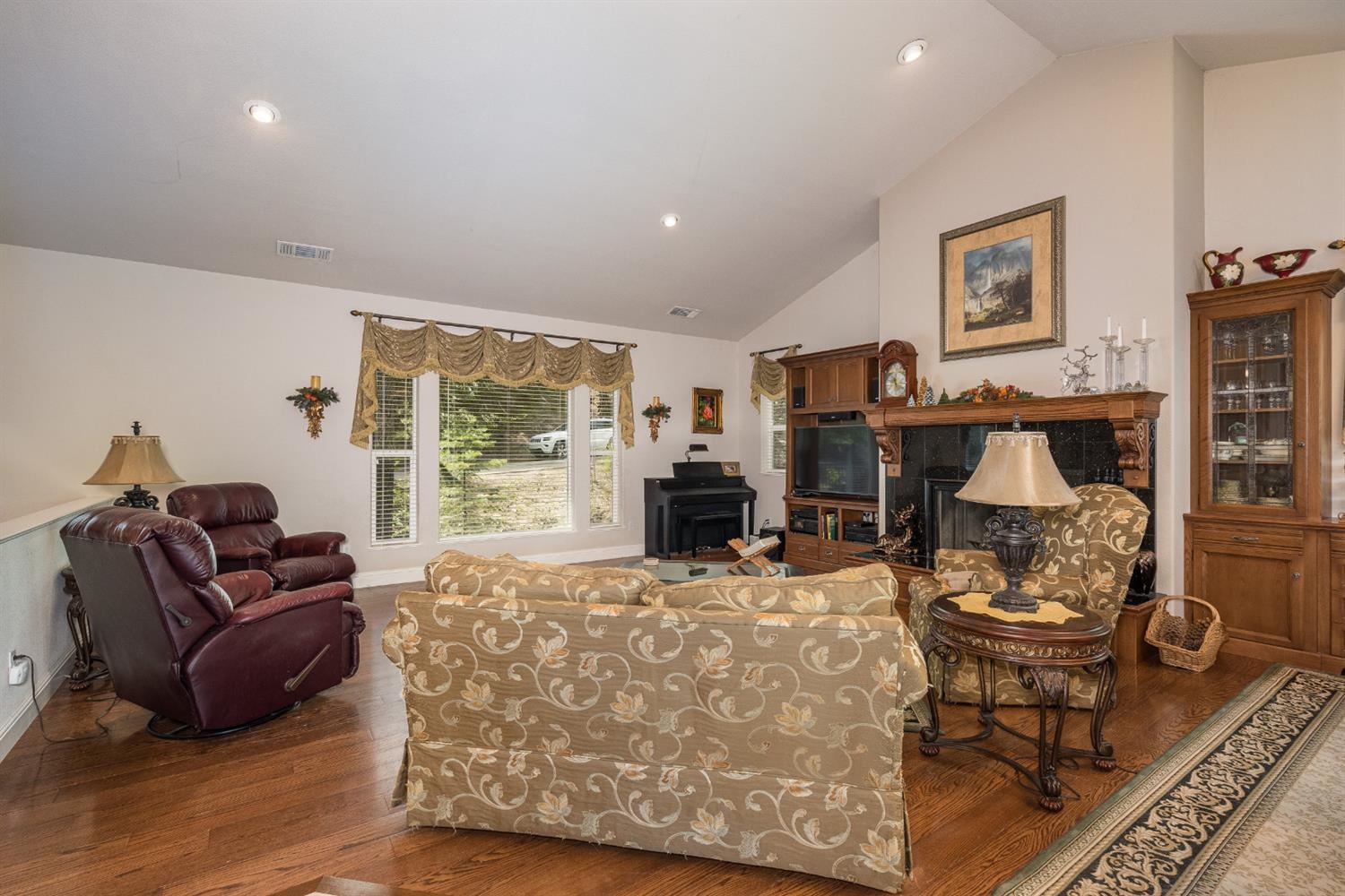 7703 Forest Drive Fish Camp, CA 93623 - Photo 8 of 48 a living room with furniture a fireplace and a large window