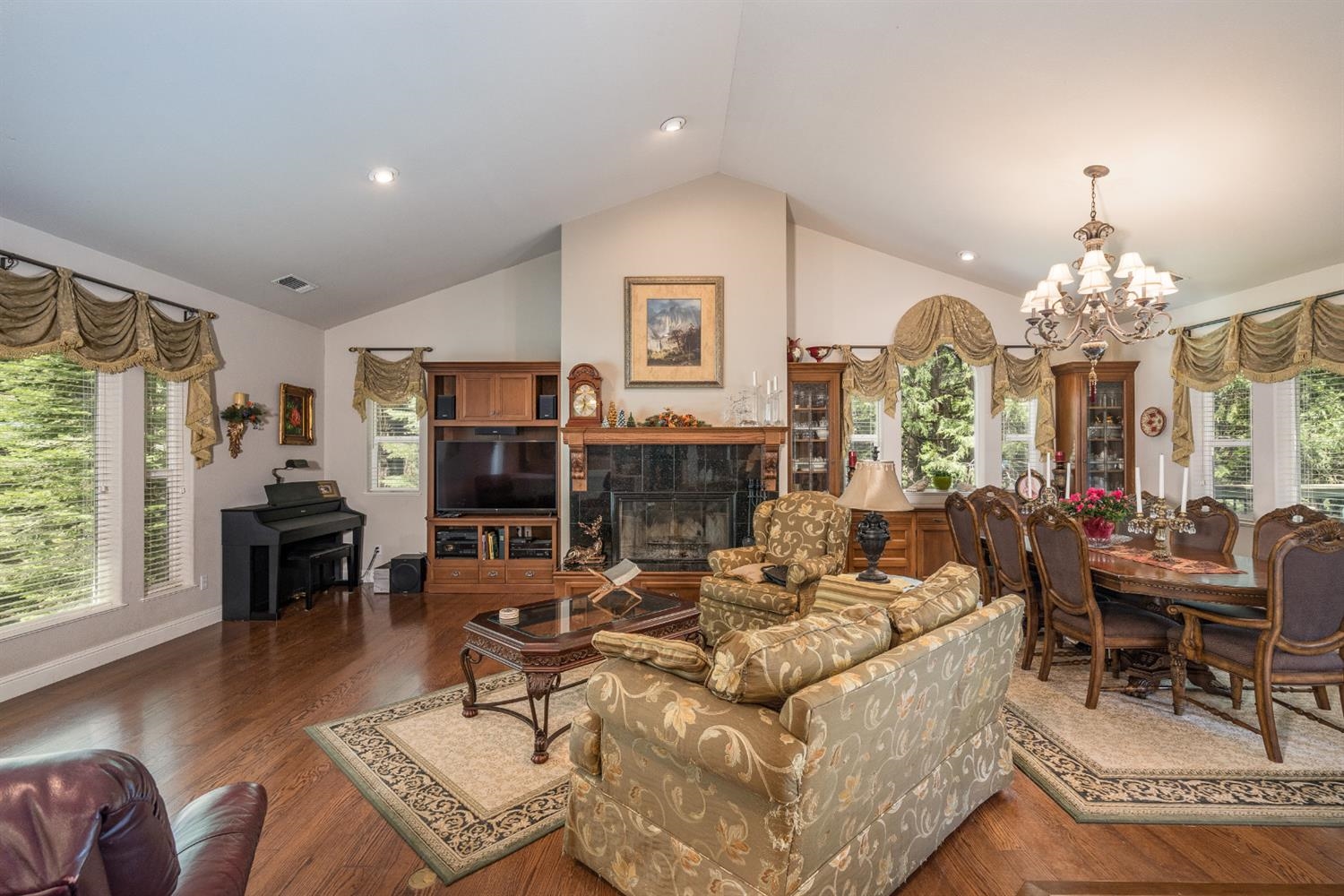 7703 Forest Drive Fish Camp, CA 93623 - Photo 9 of 48 a living room with fireplace furniture and a chandelier