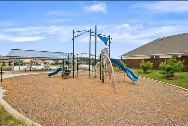 a park with water view and building in the background
