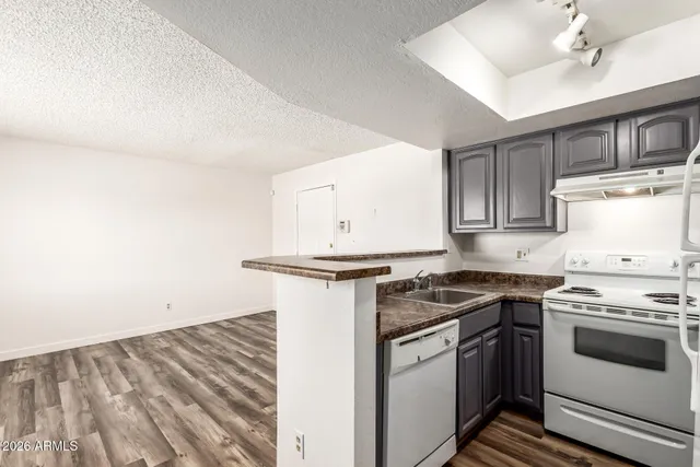 a kitchen with stainless steel appliances granite countertop a stove and a sink