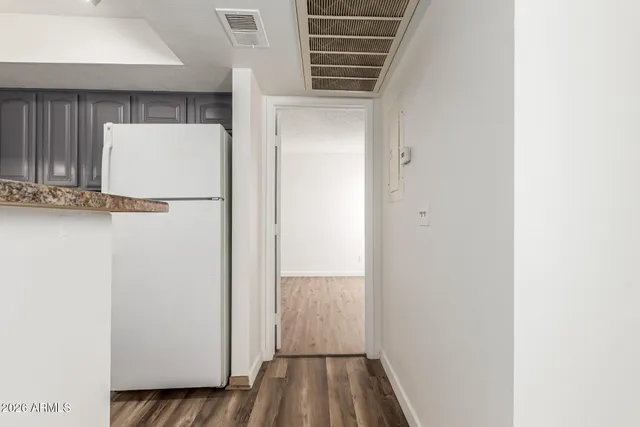 a view of walk in closet with wooden floor