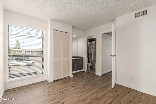 a view of a room with wooden floor and window