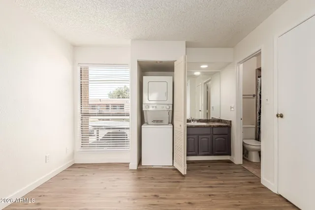 a view of a kitchen with a stove wooden cabinets and wooden floor