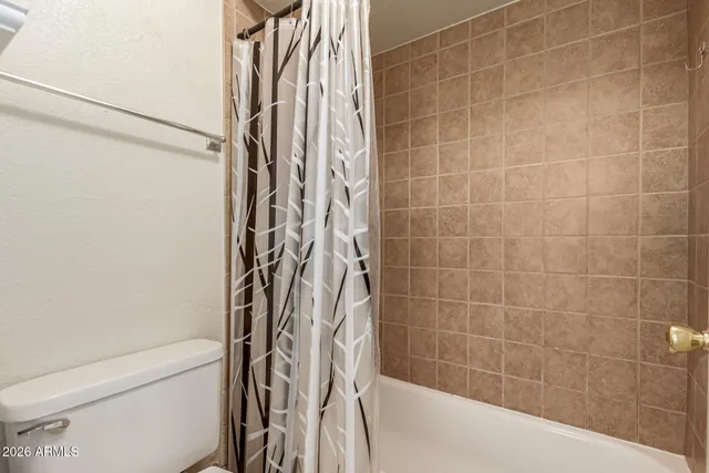 a bathroom with a shower curtain and a sink