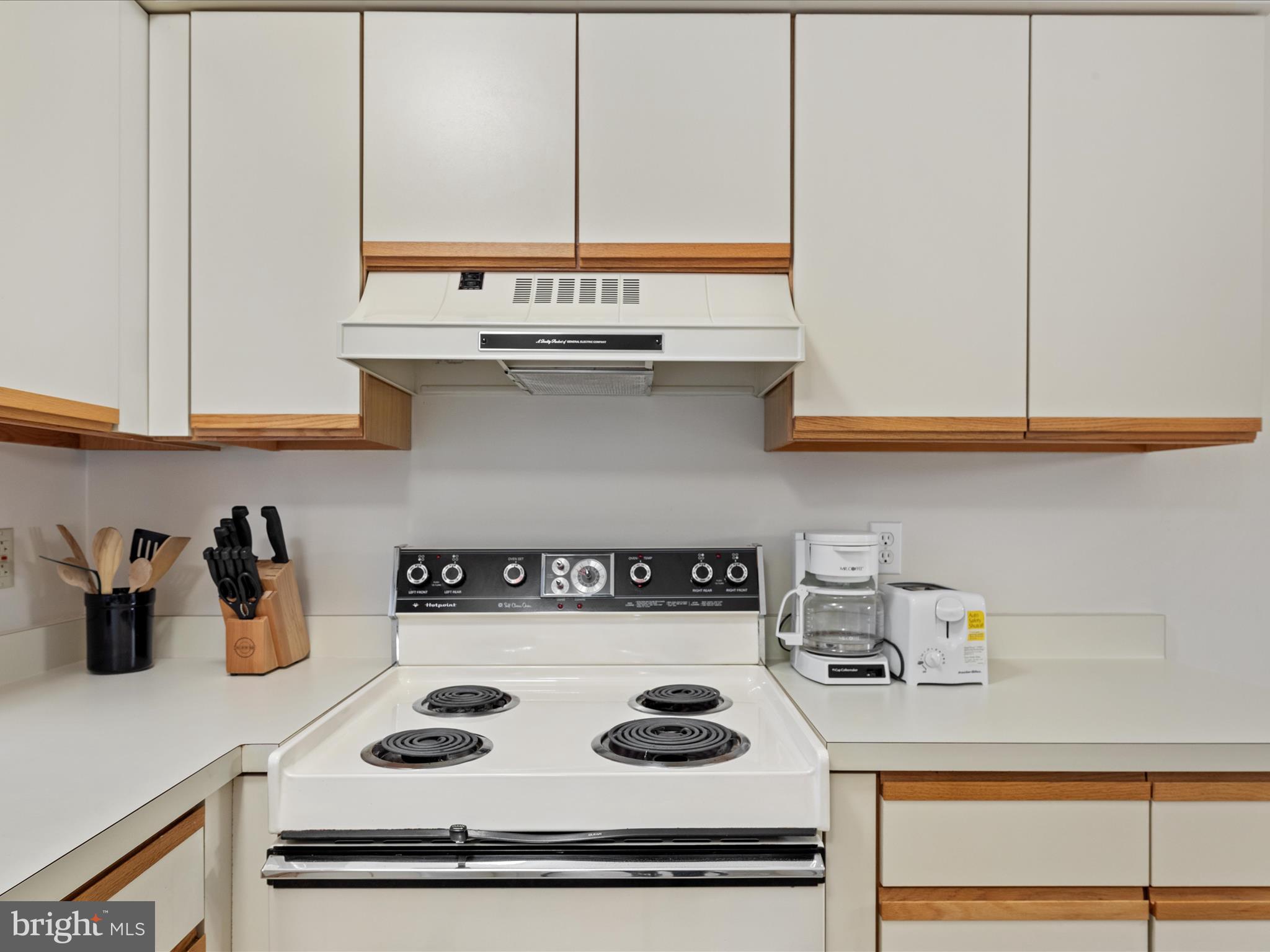 39346 Racquet Lane, Unit 8504 Bethany Beach, DE 19930 - Photo 6 of 40 a kitchen with a stove and cabinets