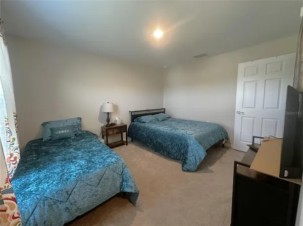 a bedroom with two beds and painted walls