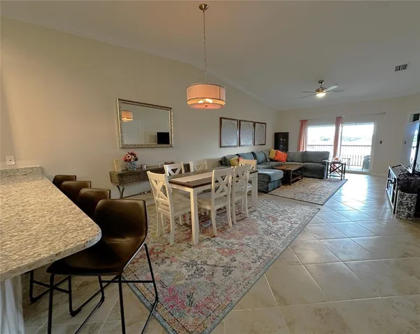 a living room with lots of furniture and a chandelier