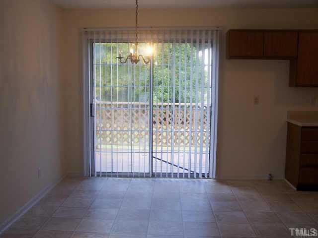 1922 Strebor Street Durham, NC 27705 - Photo 3 of 4 a view of an empty room with a fireplace and a window