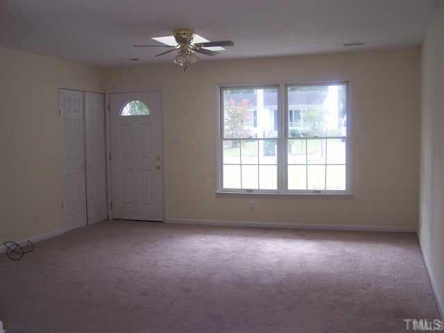 1922 Strebor Street Durham, NC 27705 - Photo 4 of 4 an empty room with windows and fan