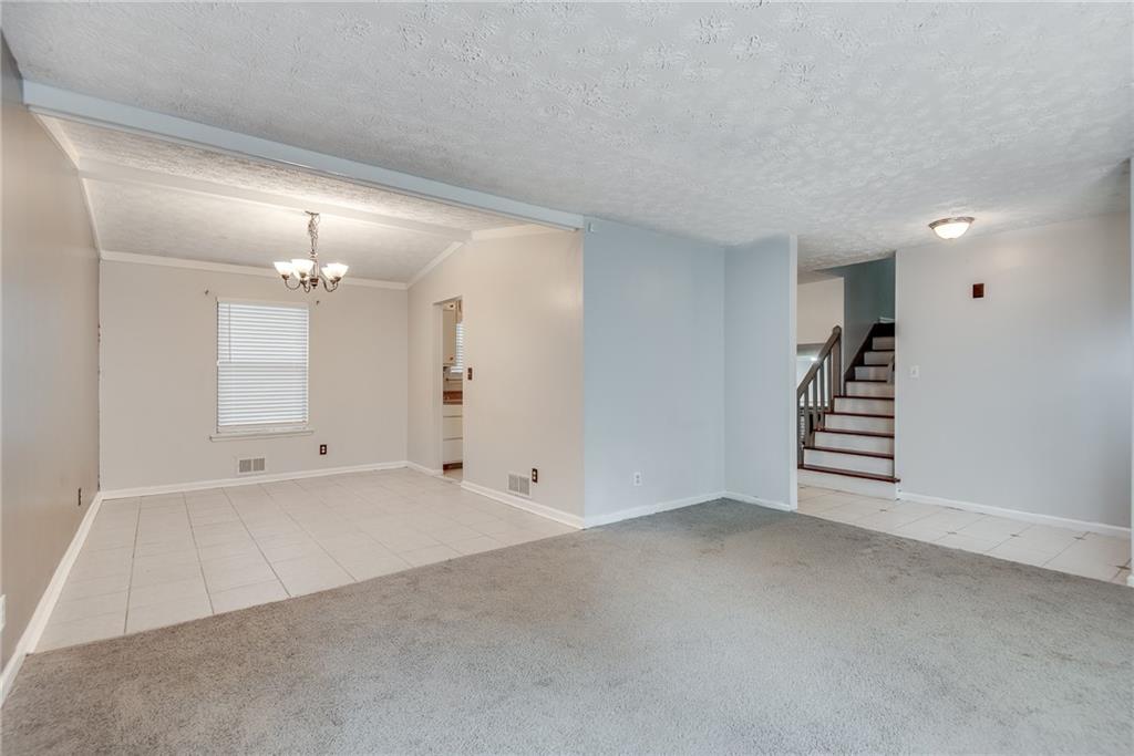 5611 Whittondale Road Lithonia, GA 30058 - Photo 3 of 34 wooden floor in an empty room with a window